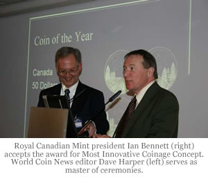 Royal Canadian Mint president Ian Bennett (right) accepts the award for Most Innovative Coinage Concept. World Coin News editor Dave Harper (left) serves as master of ceremonies.