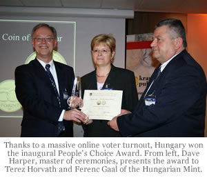 Thanks to a massive online voter turnout, Hungary won the inaugural People's Choice Award. From left, Dave Harper, master of ceremonies, presents the award to Terez Horvath and Ferenc Gaal of the Hungarian Mint.