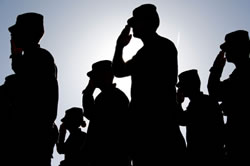Army troops saluting at sunset