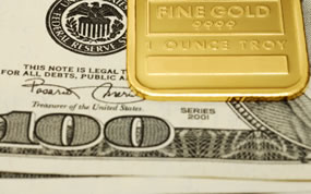 $100 Bills and Gold Bar