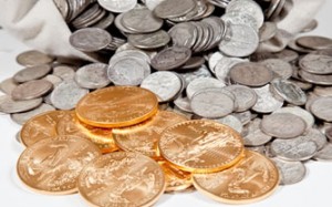 Silver coins in bag and Gold Eagle bullion coins