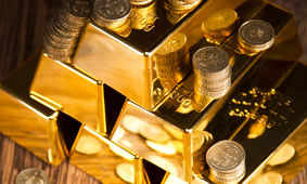 Stacks of gold bars and coins