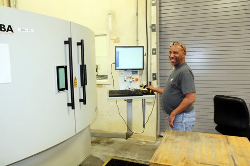 Sean Calhoun Operating Laser Serializer Machine at Denver Mint