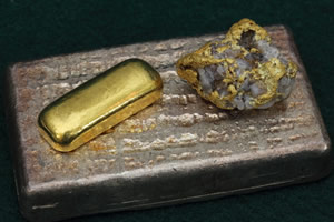Large silver bullion bar, smaller gold bar and nugget