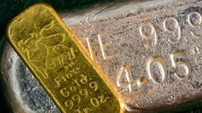 Gold, Silver Gain on Safe-Haven Demand; US Bullion Sales Up Gold bar on top of silver bar