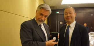 PCGS Grades Coins Year-Round in China, First 2014 Panda Coin David Hall (holding 2014 Panda coin) and Rocky Zhou