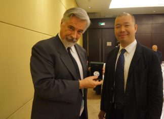 PCGS Grades Coins Year-Round in China, First 2014 Panda Coin David Hall (holding 2014 Panda coin) and Rocky Zhou