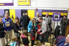 NPS official giving Mount Rushmore Quarters to local children