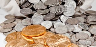 Gold Falls 2.6%, Silver Sinks 4.4%; US Mint Bullion Coins Rise Silver coins in bag and Gold Eagle bullion coins