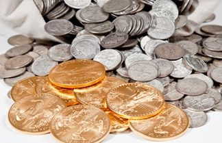 Gold Falls 2.6%, Silver Sinks 4.4%; US Mint Bullion Coins Rise Silver coins in bag and Gold Eagle bullion coins