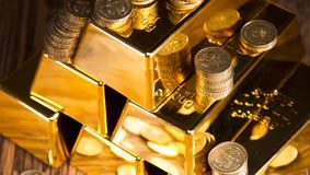 Gold Tumbles Below $1,200; Lowest Close in Over 3 Years Stacks of gold bars and coins
