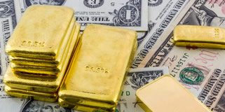 Gold Ends at 18-Week High, US Mint Bullion Coin Sales Up Gold bullion bars and US Money