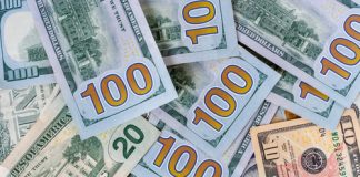 US Banknote Production Slows in May heap of dollars, money background