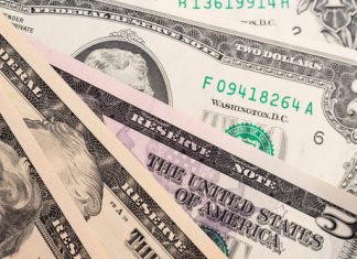 US Banknote Production Reaches 579.2 Million in March 2017 Different american dollars banknotes close-up. Background texture