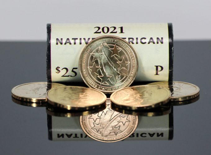 The United States Mint produced golden-colored, manganese-brass dollar coins for commerce until 2011. Federal Reserve Banks now store 1.011 billion of them. Today, the U.S. Mint strikes clad dollars but only for numismatic sales. (CoinNews photo of 2021 Native American $1 Coins.)