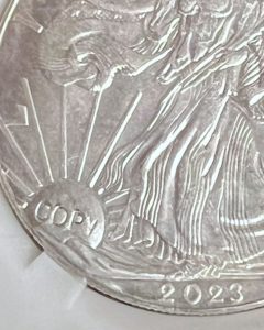 Visitors to the 2025 CSNS convention can have counterfeit coins they unwittingly purchased marked with the conspicuous, incused word “COPY,” courtesy of the Anti-Counterfeiting Educational Foundation. (Photo courtesy of ACEF.)