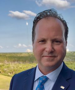 U.S. Mint Director Paul Hollis and Falcon 9 rocket